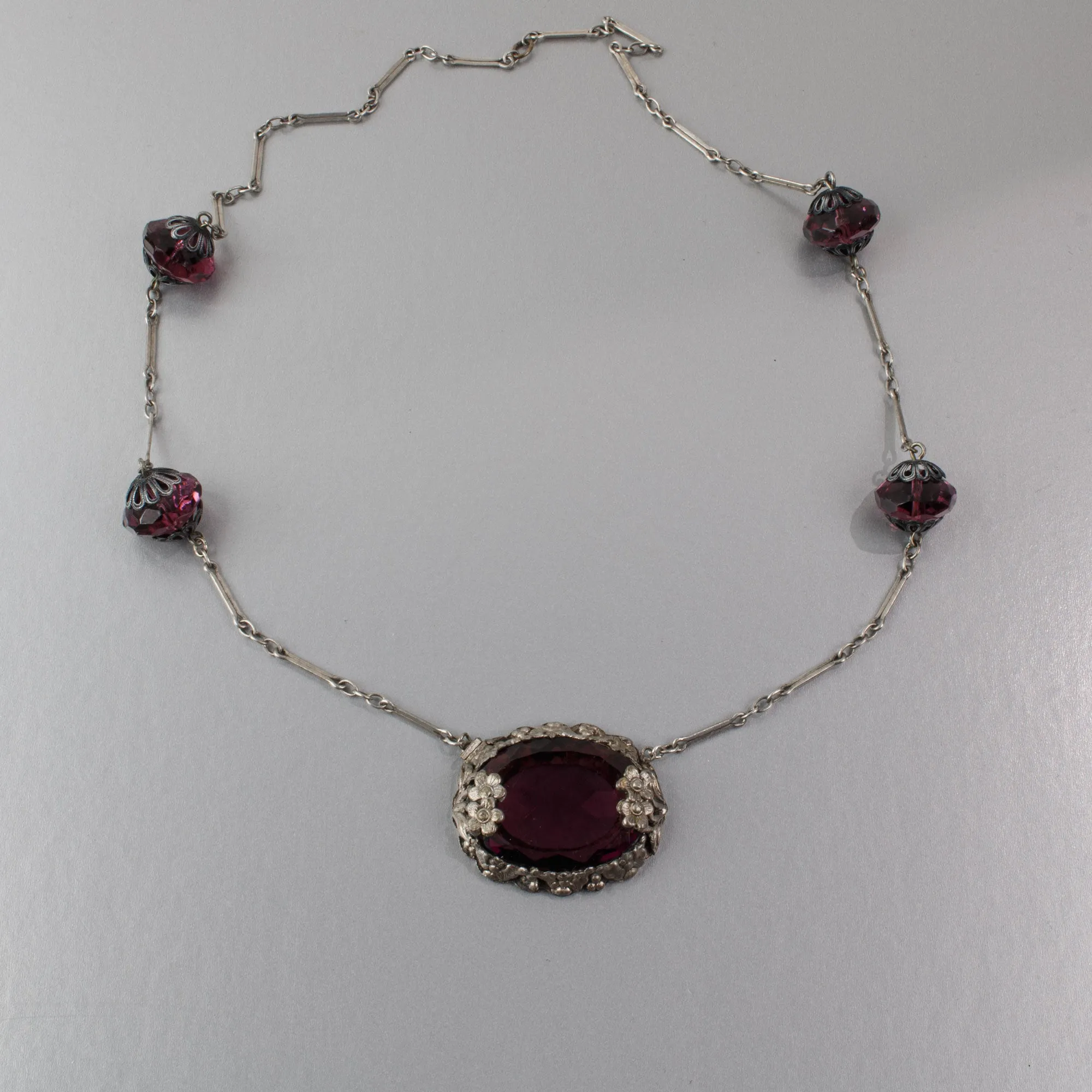 Art Deco pendant necklace, amethyst glass with floral bezel j-NLAD991